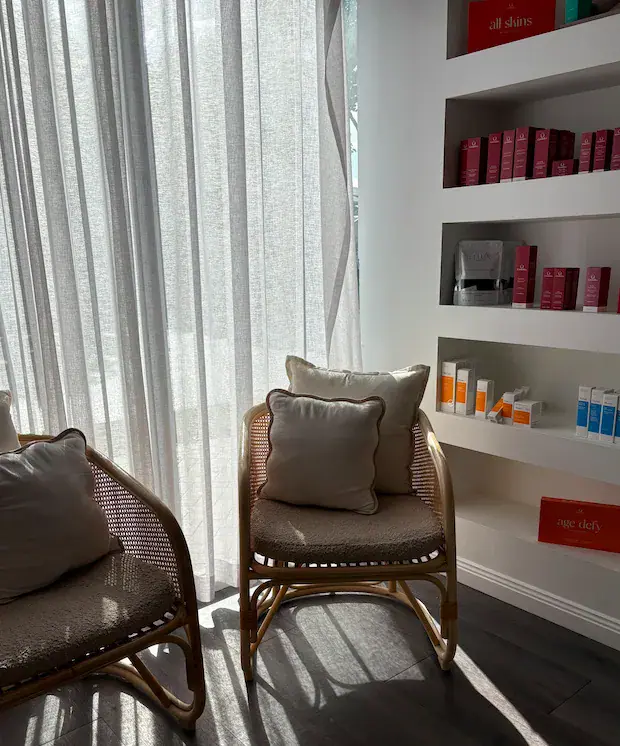 A cane chair in soft light beside the treatment rooms
