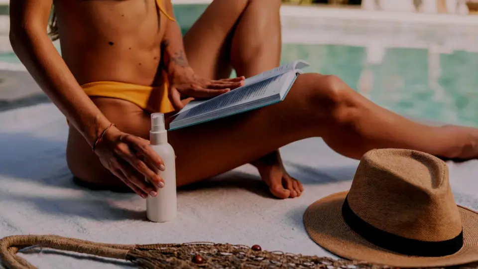 Tanning lotion being applied to sun-warmed skin
